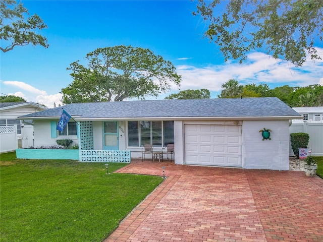 ranch-style home with an attached garage, decorative driveway, a shingled roof, and covered porch