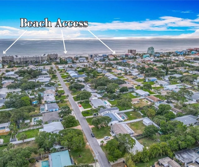 aerial view of property's location with a large body of water