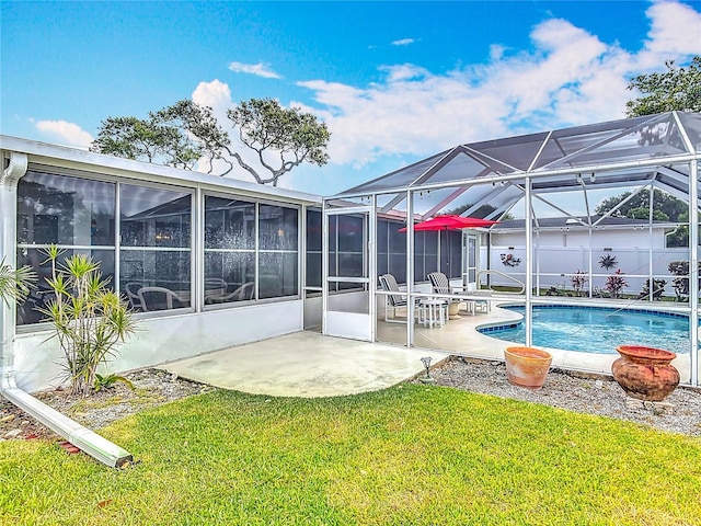 outdoor pool featuring a yard, a patio, and a lanai