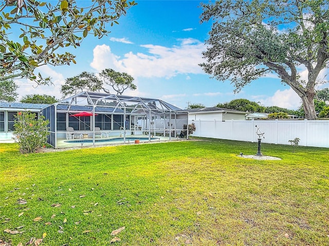 view of yard with an outdoor pool and a lanai