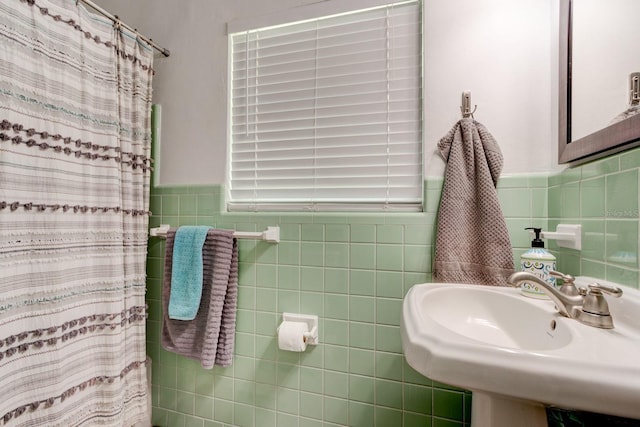 184 Azalea Rd, Edgewater, FL 32141 - full bathroom featuring a sink, curtained shower, tile walls, and wainscoting