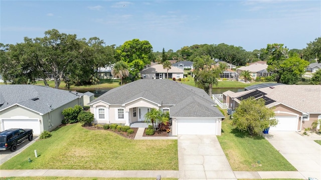 404 Central Mariners Dr, Edgewater, FL 32141 - view of front facade featuring a residential view, driveway, a garage, a front yard, and roof with shingles