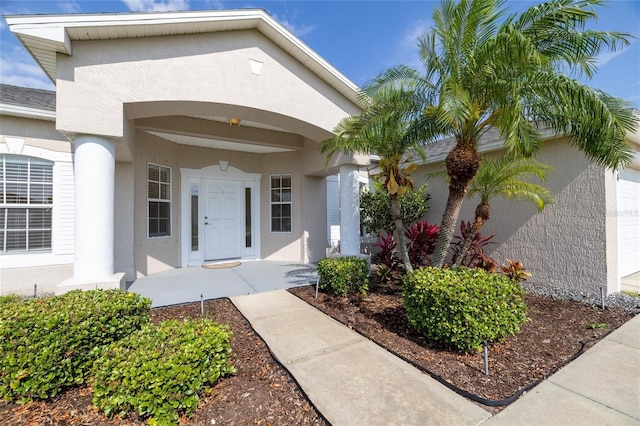 404 Central Mariners Dr, Edgewater, FL 32141 - property entrance with stucco siding and a garage