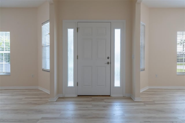 404 Central Mariners Dr, Edgewater, FL 32141 - entryway featuring light wood-type flooring, healthy amount of natural light, and baseboards