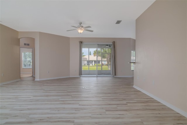 404 Central Mariners Dr, Edgewater, FL 32141 - empty room with a ceiling fan, light wood-style flooring, baseboards, and arched walkways