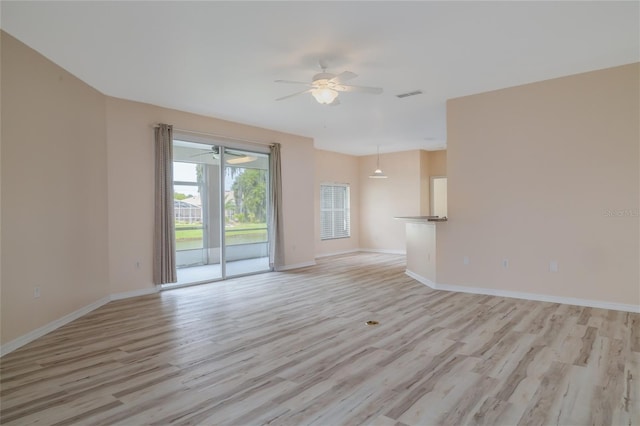 404 Central Mariners Dr, Edgewater, FL 32141 - unfurnished living room featuring light wood finished floors, a ceiling fan, and baseboards