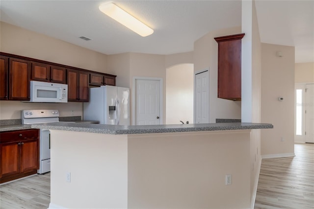 404 Central Mariners Dr, Edgewater, FL 32141 - kitchen featuring white appliances, light wood finished floors, a peninsula, and baseboards