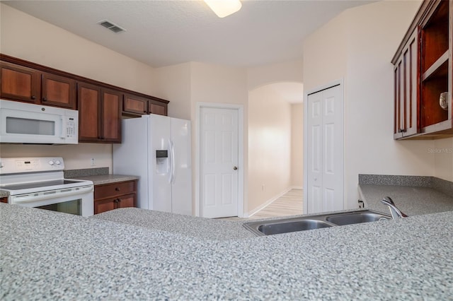 404 Central Mariners Dr, Edgewater, FL 32141 - kitchen with white appliances, a sink, open shelves, and arched walkways