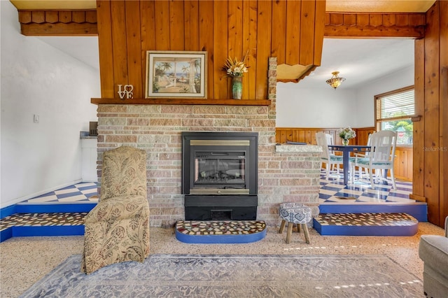 detailed view of a glass covered fireplace and wood walls