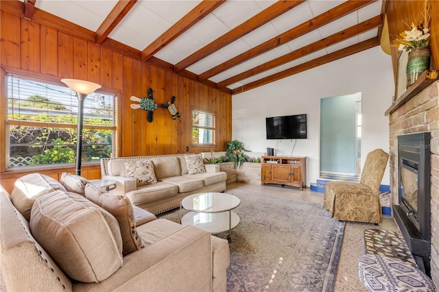 living room with a fireplace, beamed ceiling, high vaulted ceiling, and wood walls