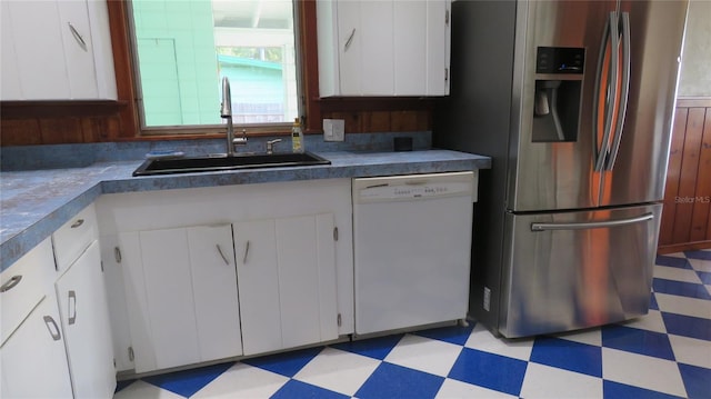 kitchen with stainless steel fridge with ice dispenser, white dishwasher, light floors, a sink, and white cabinets