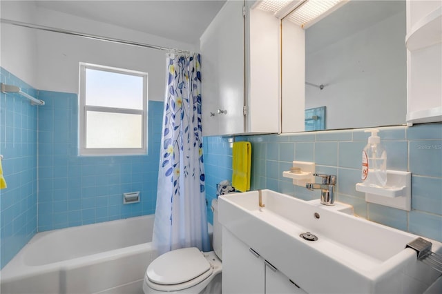 full bathroom featuring tile walls, toilet, shower / bath combo with shower curtain, and vanity