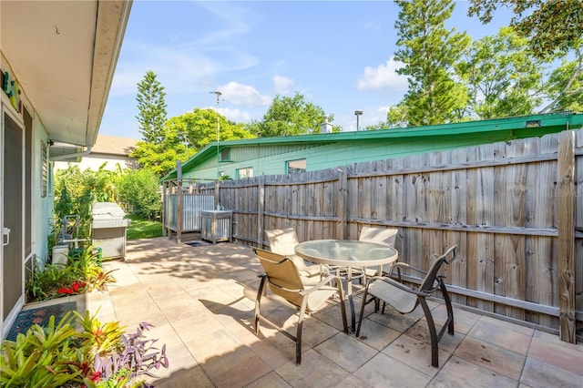 view of patio / terrace featuring fence and outdoor dining space