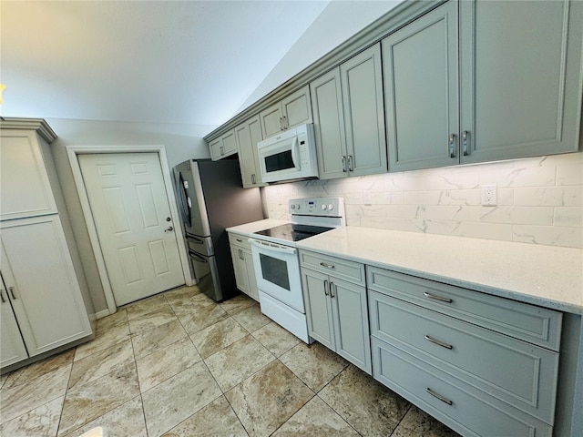 3303 Victory Palm Dr, Edgewater, FL 32141 - kitchen featuring white appliances, lofted ceiling, and decorative backsplash