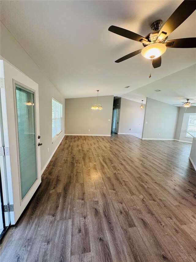 3303 Victory Palm Dr, Edgewater, FL 32141 - unfurnished living room with dark wood-type flooring, a ceiling fan, a chandelier, and baseboards