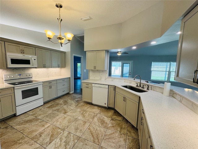 3303 Victory Palm Dr, Edgewater, FL 32141 - kitchen featuring white appliances, a sink, a chandelier, tasteful backsplash, and light countertops