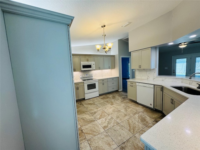 3303 Victory Palm Dr, Edgewater, FL 32141 - kitchen with white appliances, a sink, vaulted ceiling, a chandelier, and decorative backsplash