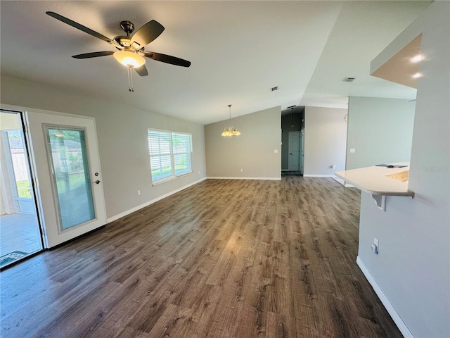 3303 Victory Palm Dr, Edgewater, FL 32141 - unfurnished living room with dark wood-style floors, lofted ceiling, baseboards, ceiling fan, and a chandelier