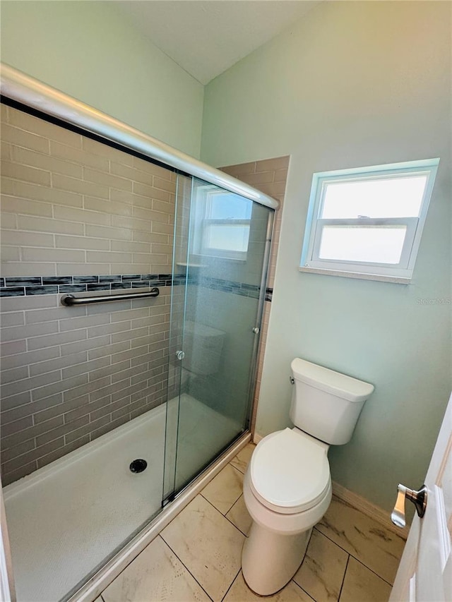 3303 Victory Palm Dr, Edgewater, FL 32141 - bathroom with a stall shower, toilet, and marble look tiles