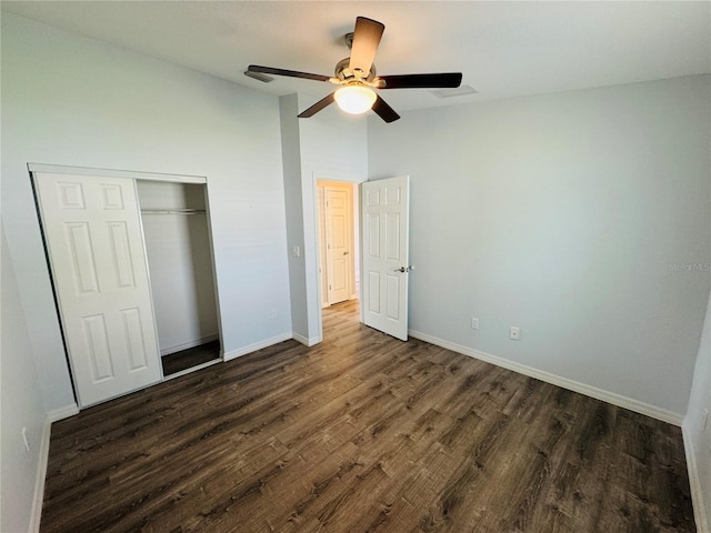 3303 Victory Palm Dr, Edgewater, FL 32141 - unfurnished bedroom with dark wood-style flooring, baseboards, a closet, a ceiling fan, and lofted ceiling