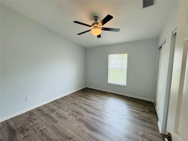 3303 Victory Palm Dr, Edgewater, FL 32141 - unfurnished bedroom with wood finished floors, baseboards, and ceiling fan