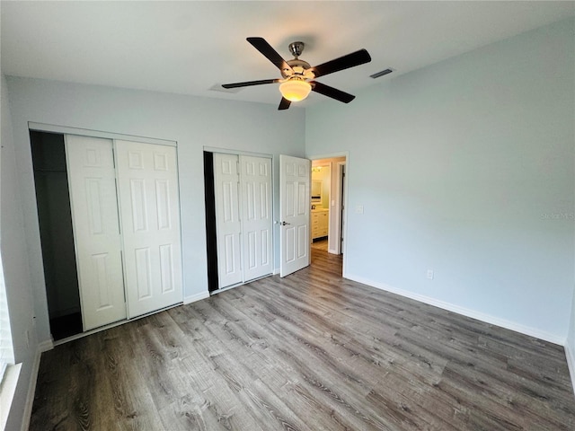 3303 Victory Palm Dr, Edgewater, FL 32141 - unfurnished bedroom featuring two closets, wood finished floors, and baseboards