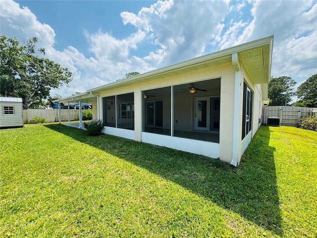 3303 Victory Palm Dr, Edgewater, FL 32141 - back of house with a sunroom, a ceiling fan, cooling unit, an outbuilding, and a shed