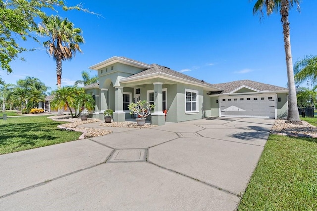 637 Marisol Dr, New Smyrna Beach, FL 32168 - view of front of property with driveway, a garage, stucco siding, and a front lawn