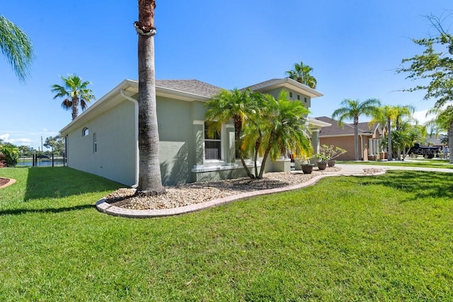 637 Marisol Dr, New Smyrna Beach, FL 32168 - view of property exterior featuring stucco siding and a yard