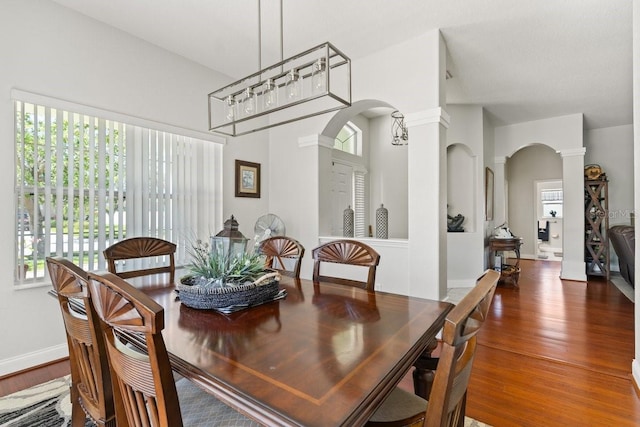 637 Marisol Dr, New Smyrna Beach, FL 32168 - dining room with arched walkways, ornate columns, healthy amount of natural light, and wood finished floors