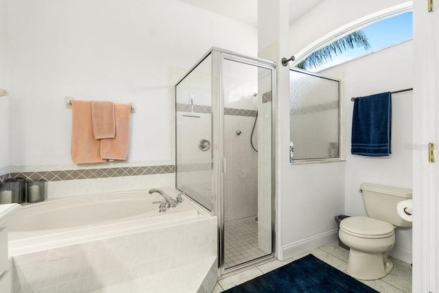 637 Marisol Dr, New Smyrna Beach, FL 32168 - bathroom featuring a garden tub, a stall shower, tile patterned floors, and toilet
