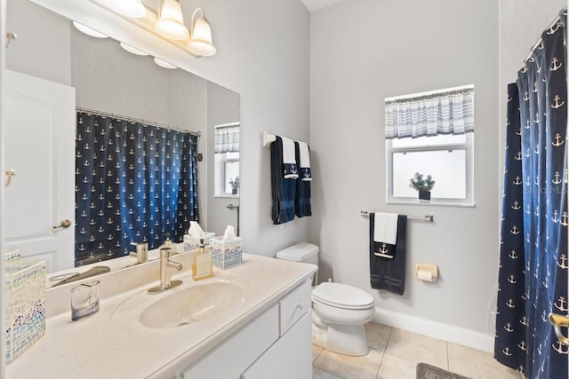 637 Marisol Dr, New Smyrna Beach, FL 32168 - bathroom with tile patterned floors, toilet, plenty of natural light, and vanity