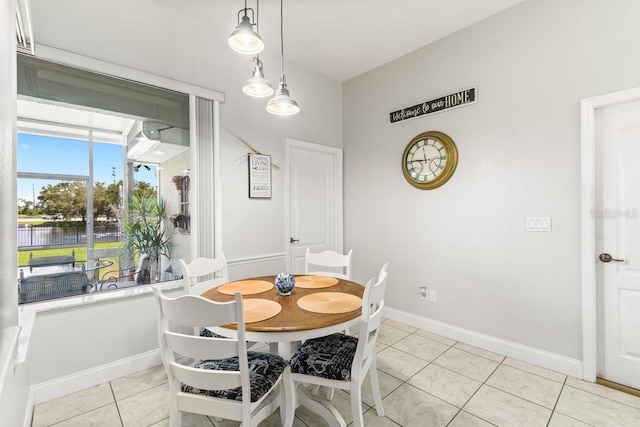 637 Marisol Dr, New Smyrna Beach, FL 32168 - dining space featuring a water view, light tile patterned flooring, and baseboards