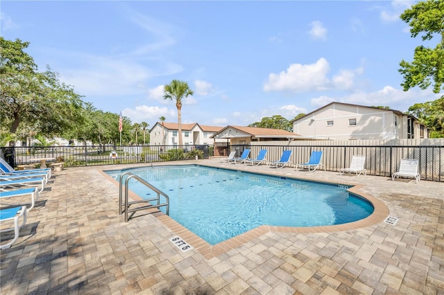 community pool featuring a patio and fence
