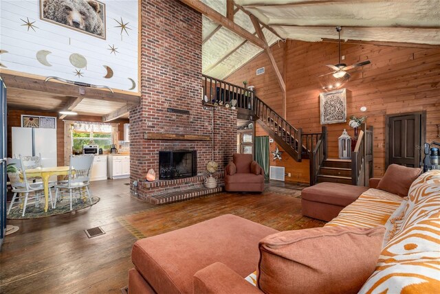 4580 Lake James Cir, Edgewater, FL 32141 - living area featuring wood walls, stairs, hardwood / wood-style flooring, a brick fireplace, and ceiling fan