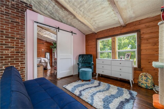 4580 Lake James Cir, Edgewater, FL 32141 - living area with a barn door, hardwood / wood-style floors, wooden walls, and a textured ceiling