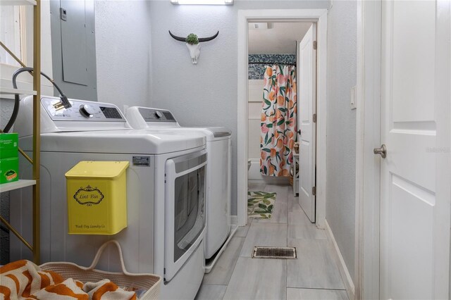 4580 Lake James Cir, Edgewater, FL 32141 - laundry area with separate washer and dryer, baseboards, and electric panel