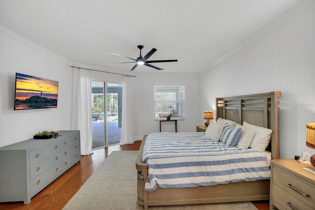 bedroom featuring access to exterior, crown molding, wood finished floors, and ceiling fan