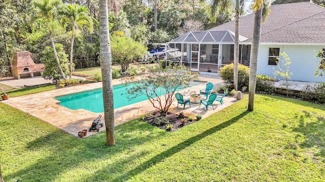 outdoor pool featuring a patio area, a lawn, and glass enclosure