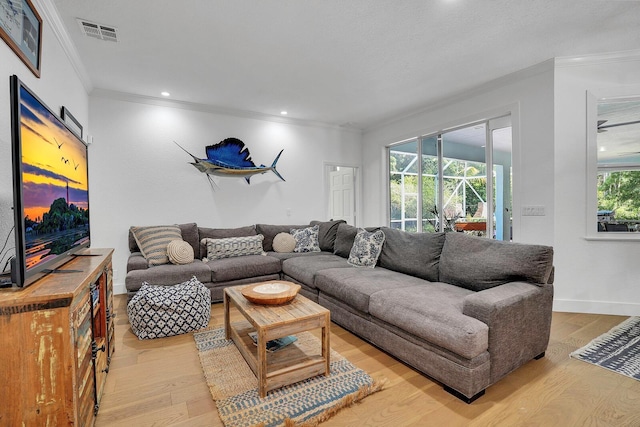 living room with crown molding, light wood finished floors, healthy amount of natural light, recessed lighting, and baseboards