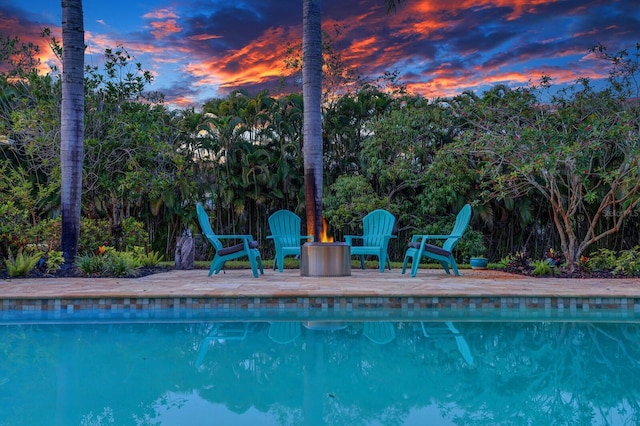 pool at dusk featuring an outdoor pool