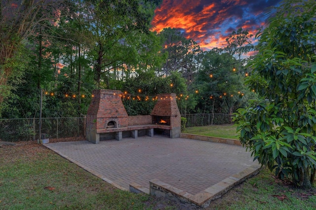 view of patio / terrace with a lit fireplace