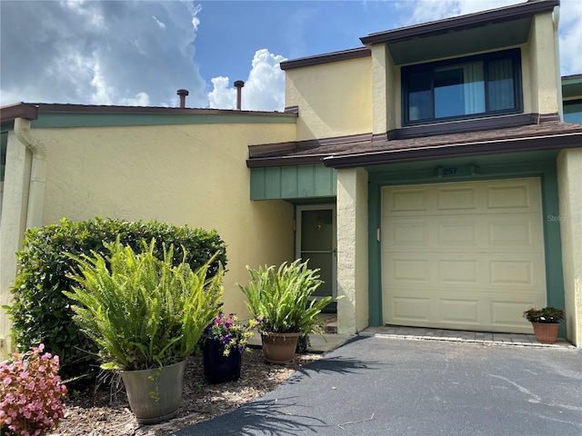 257 Club House Blvd, New Smyrna Beach, FL 32168 - property entrance featuring stucco siding and an attached garage
