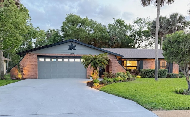 208 Wellington Dr, Daytona Beach, FL 32119 - single story home featuring brick siding, concrete driveway, a garage, and a front yard