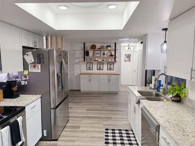 208 Wellington Dr, Daytona Beach, FL 32119 - kitchen with stainless steel appliances, a raised ceiling, a sink, and white cabinetry