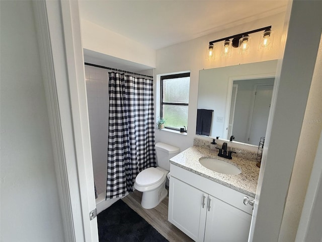 208 Wellington Dr, Daytona Beach, FL 32119 - bathroom with vanity, toilet, a shower with curtain, and wood finished floors