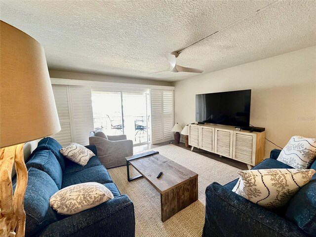 2100 N Peninsula Ave Unit 2160, New Smyrna Beach, FL 32169 - living area with ceiling fan and a textured ceiling