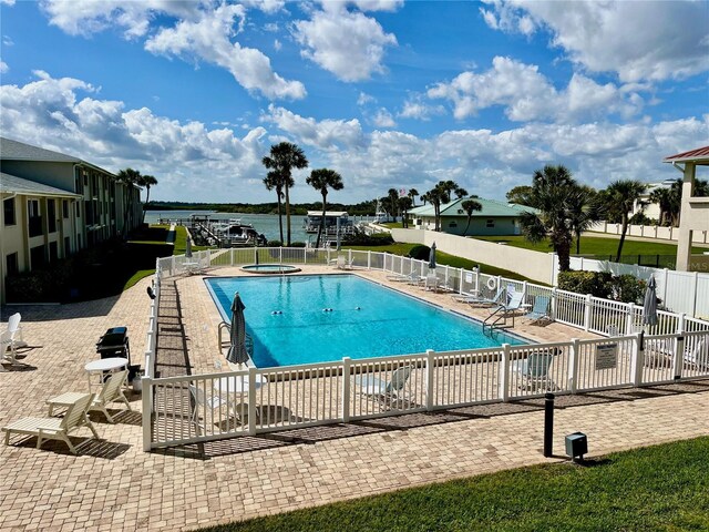2100 N Peninsula Ave Unit 2160, New Smyrna Beach, FL 32169 - community pool with a community hot tub, a patio area, fence, and a water view