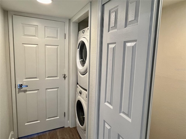 2100 N Peninsula Ave Unit 2160, New Smyrna Beach, FL 32169 - clothes washing area featuring estacked washer and dryer and dark wood-type flooring