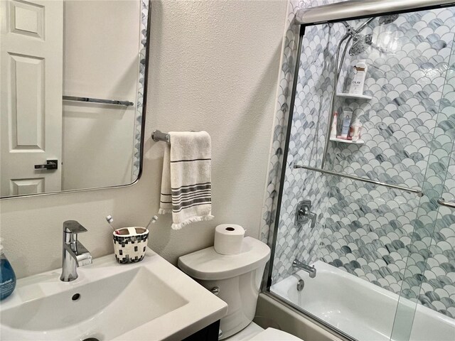 2100 N Peninsula Ave Unit 2160, New Smyrna Beach, FL 32169 - full bathroom featuring a textured wall, shower / bath combination with glass door, toilet, and vanity